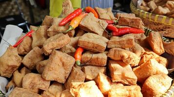 Fried tofu and chili in a bamboo basket photo