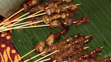 sate usus or chiken intestines satay and sate hati or liver satay. photo