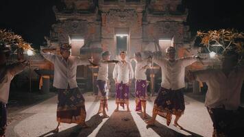 Traditional dance performance in front of illuminated ancient temple at night video