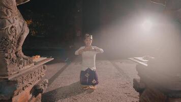 Person kneeling with wooden object in traditional setting video