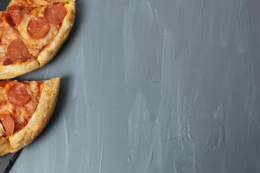 Pepperoni triangle pizza on a gray background with space for text upper angle Shooting in the studio photo