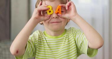 Child Holding Letters B and A Before Eyes video