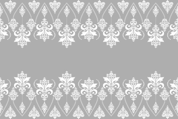 White damask seamless pattern of floral and leaf motifs on grey background