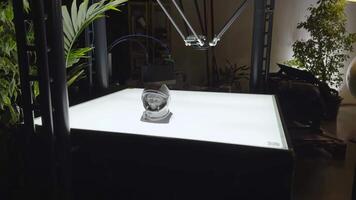 A detailed 3D printed bust of a Soviet cosmonaut, showcased on a lighted display table with robotic arms in the background. Ideal for themes related to space exploration and 3D printing technology. video
