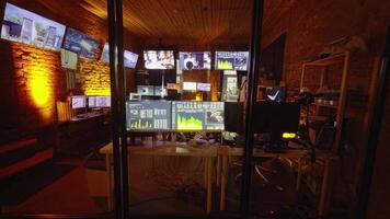 A high-tech control room equipped with multiple monitors displaying various data and feeds. Ideal for themes related to technology, data analysis, and surveillance systems video