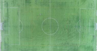 aerial top view with drone of a soccer field with soccer players of a team training video