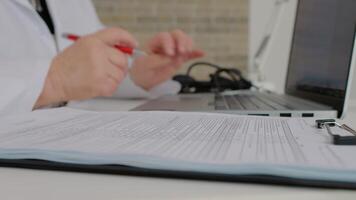 Checklists of recent patients done by doctor on laptop and also on paper. video