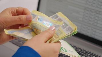 Rich woman enjoying euro banknotes in hands by counting them in special way. video