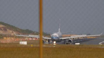 Airplane braking after landing. View of the runway through the airport fence. Passenger flight arriving video