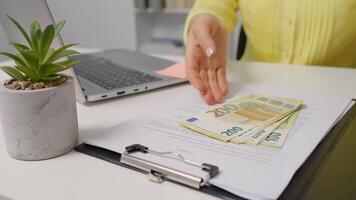 Opening a clipboard female hands counting bill for payday. video