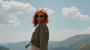 Portrait of woman smiling on camera by achieving the top of a mount. video