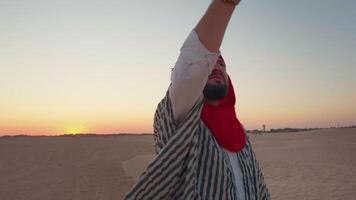 Man trying to search signal with cellphone walking on desert. video