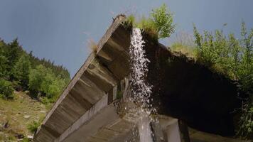 Shot from underneath of waterfall stream from a cement bridge. video