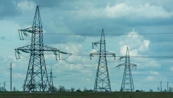 High voltage towers with sky background. Power line support with wires for electricity transmission. High voltage grid tower with wire cable at distribution station. Energy industry, energy saving photo