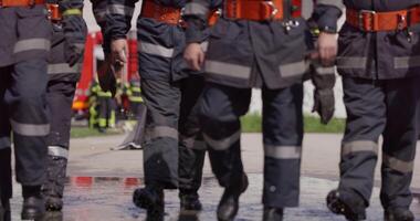 A specialized firefighting unit equipped with special attire and advanced equipment embarks on a hazardous fire suppression mission, showcasing their professionalism and readiness to combat fires in video