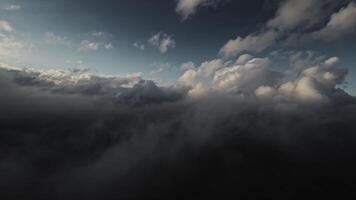 Aerial view Flying over the clouds timelapse with daytime sun. Flying through moving clouds with beautiful reflections. Air travel. Ideal for cinema, background video