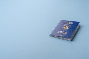 Biometric Ukrainian passport on a blue background photo