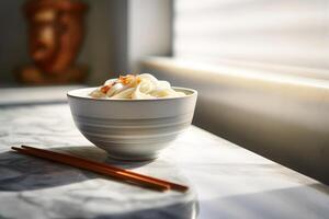 Japanese udon noodles in a bowl with chopsticks on a white table photo