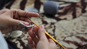 Female hands close-up. Handmade. Colored yarn and knitting needles. photo