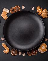Beautiful festive Christmas composition of an empty plate, gingerbreads and star anise photo