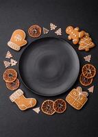 Beautiful festive Christmas composition of an empty plate, gingerbreads and star anise photo