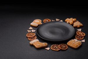 Beautiful festive Christmas composition of an empty plate, gingerbreads and star anise photo
