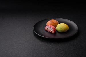 Delicious colorful asian mochi sweets with rice dough shell photo
