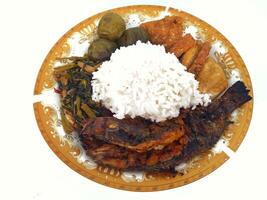 A closeup view of grilled white fish, in a restaurant or kitchen setting. photo