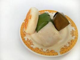 Various traditional Indonesian cakes in the market.Traditional market snacks from Indonesia are nagasari, mendut wrapped in banana leaves photo
