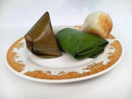 Various traditional Indonesian cakes in the market.Traditional market snacks from Indonesia are nagasari, mendut wrapped in banana leaves photo
