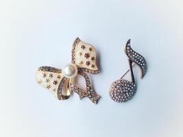 Accessories shaped like butterflies and melodies in yellow and white with imitation gems are suitable for use at events and add to the elegance of women. on white background photo
