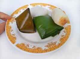Various traditional Indonesian cakes in the market.Traditional market snacks from Indonesia are nagasari, mendut wrapped in banana leaves photo
