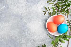 Easter eggs painted by hand colored on a concrete table, top view. copy space photo