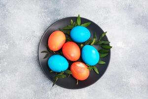 Easter eggs painted by hand colored on a concrete table, top view. copy space photo