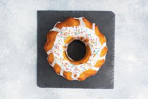 Easter cake in icing sugar on the table. Top view photo
