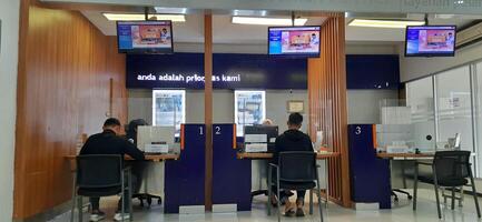 View of the Pasar Senen train station area. Local train and passengers activity. Jakarta, Indonesia - June 8, 2024 photo
