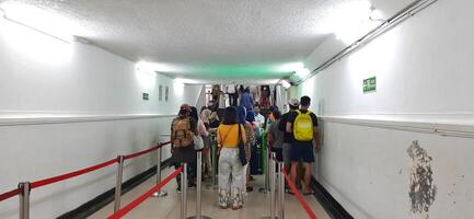 View of the Pasar Senen train station area. Local train and passengers activity. Jakarta, Indonesia - June 8, 2024 photo