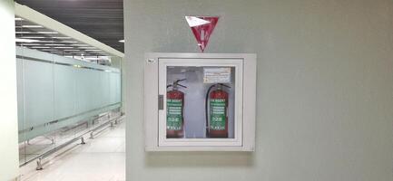 Two hydrants in a box attached to the wall in the terminal 1A Jakarta Indonesia June 11 2024 photo