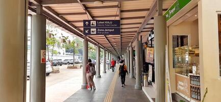 View of the Pasar Senen train station area. Local train and passengers activity. Jakarta, Indonesia - June 8, 2024 photo