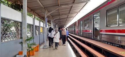 View of the Pasar Senen train station area. Local train and passengers activity. Jakarta, Indonesia - June 8, 2024 photo
