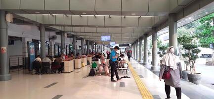 View of the Pasar Senen train station area. Local train and passengers activity. Jakarta, Indonesia - June 8, 2024 photo