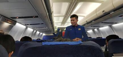 Passengers are sitting in the plane. Jakarta, Indonesia - June 11 2024 photo