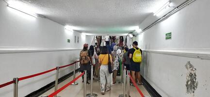 View of the Pasar Senen train station area. Local train and passengers activity. Jakarta, Indonesia - June 8, 2024 photo