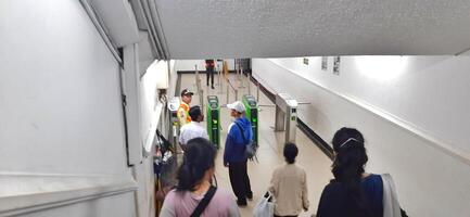 View of the Pasar Senen train station area. Local train and passengers activity. Jakarta, Indonesia - June 8, 2024 photo