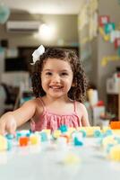 portrait of latin american little child playing with colored block photo