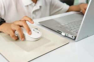 Hands of child using a laptop in a classroom. Exploring Modern Education Concept. A Study on Interactivity and Inclusion in the Classroom. photo