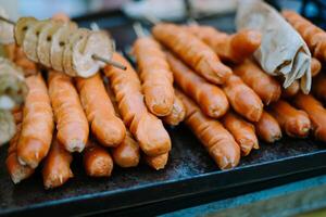 Grilled sausages sizzling on the barbecue, showcasing a delicious and savory treat perfect for outdoor gatherings photo