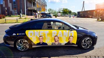 Warsaw, Poland. 9 July 2024. Onet.pl polish web portal logo on Hyundai electric car. Journalists conduct interviews while driving around the city. photo