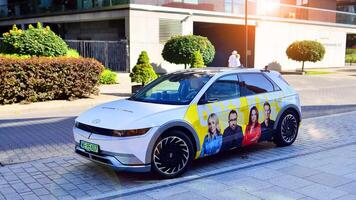Warsaw, Poland. 9 July 2024. Onet.pl polish web portal logo on Hyundai electric car. Journalists conduct interviews while driving around the city. photo