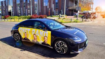 Warsaw, Poland. 9 July 2024. Onet.pl polish web portal logo on Hyundai electric car. Journalists conduct interviews while driving around the city. photo